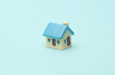 Toy house miniature on blue background