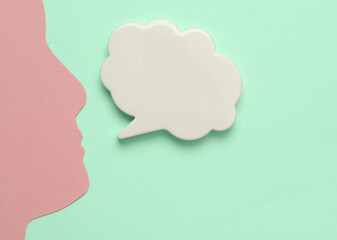 Speech bubble with head silhouette on blue background
