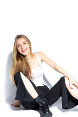 Fototapeta premium Playful Smiling Sensual Charming Female Blond Girl Sitting While Laughing Over Pure White Background.