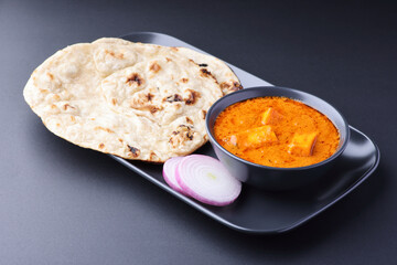Paneer butter masala with roti and chopped onion Indian lunch
