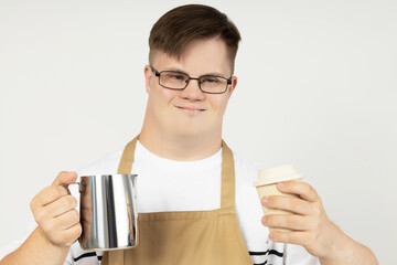 A boy with down syndrome as a barista in an apron and with coffee