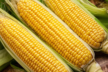 Ripe corn heads with corn whiskers and leaves.