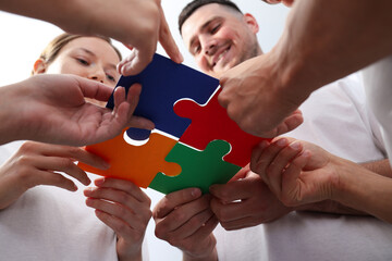Puzzles in human hands on white background, close up