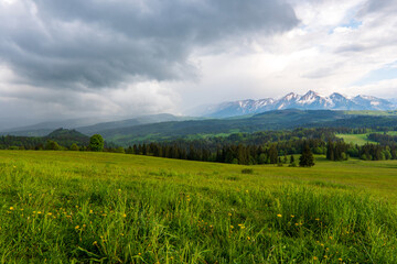 Fototapeta premium Dark clouds and rain storm over the rice field, rainy season in Tatras mountain poland