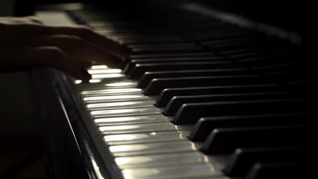 Close up movie camera in slow motion Male pianist plays fast music on piano