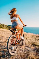Foto op Canvas Sporty attractive woman with bicycle in outdoor. Lifestyle with young lady.. © artifirsov