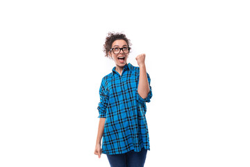 young smiling energetic curly european woman dressed casually in a blue plaid shirt on a white background