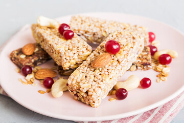 Various granola bars on table background. Cereal granola bars. Superfood breakfast bars with oats,...