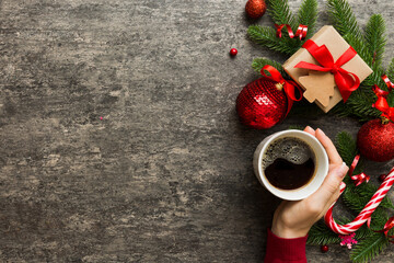 Woman holding cup of coffee. Woman hands holding a mug with hot coffee. Winter and Christmas time...