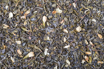 Dried natural large tea leaves close up. Chinese jasmine tea Hua Zhu Cha.
