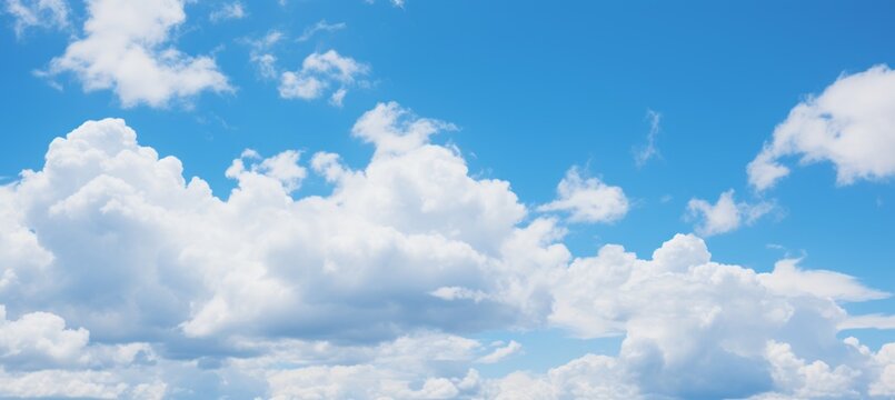Beautiful blue sky with fluffy white clouds   serene natural outdoor background image
