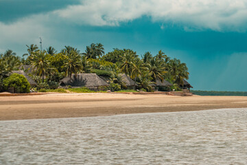 View of beach against resorts aamidst palm trees in Manda Island, Lamu Island, Kenya