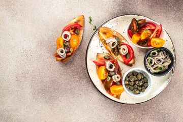 Anchovies toasts with fresh tomato, olive oil. Tapas - Spanish food. top view. copy space