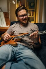 Caucasian middle aged man playing the guitar.