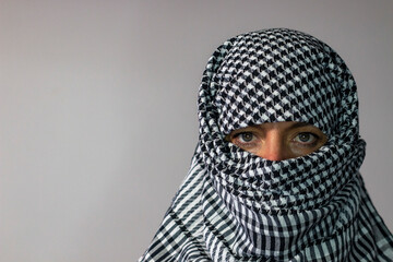 Green-eyed woman wearing a Palestinian scarf. Conflict concept