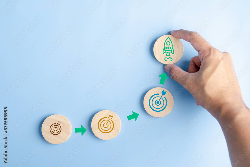 Aufkleber hand holding objective aiming target and rocket ship launch arrow up to leadership and customer targ