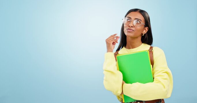 Happy woman, student and thinking in studio with ideas, vision or good memory on blue background. Learning, remember or gen z girl brainstorming with decision, choice or future with planning or books