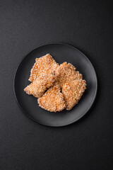Delicious fresh crispy chicken nuggets on a dark concrete background
