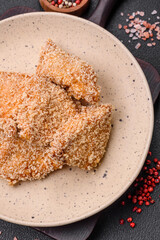 Delicious fresh crispy chicken nuggets on a dark concrete background