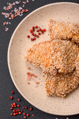 Delicious fresh crispy chicken nuggets on a dark concrete background
