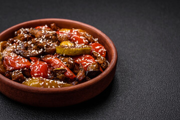 Warm salad with veal, tomatoes, peppers, zucchini, sesame, salt, spices and herbs