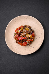 Warm salad with veal, tomatoes, peppers, zucchini, sesame, salt, spices and herbs