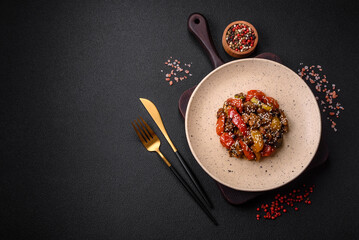 Warm salad with veal, tomatoes, peppers, zucchini, sesame, salt, spices and herbs