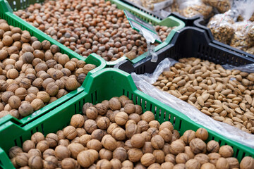 many different fresh nuts lie in boxes in the store