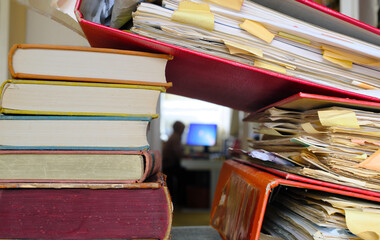 heap of file folders and blurred workplace in the background.Business concept,home office,freelance...