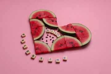 Combination of watermelon slices forming heart shape, sprinkled seeds and wooden cubes with words...