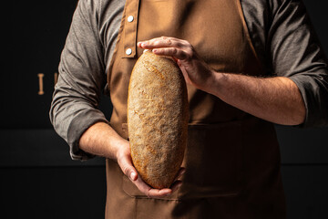 bran bread in men's hands, Healthy food concept. place for text