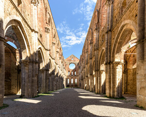 Perspective of central nave in abandoned San Galgano Abbey church, an abandoned medieval monastery in Chiusdino village, Tuscany, Italy - obrazy, fototapety, plakaty