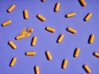 Top view pattern orange pills on violet background