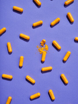 Top view pattern orange pills on violet background