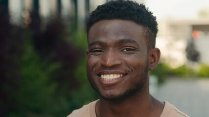 Close up male face happiness expression portrait African American happy smiling guy in city laugh funny reaction enjoy biracial man smile toothy white teeth dental service dentistry medicine outdoors
