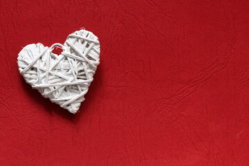 Valentines day white heart on red paper background. Holidays card with copy space.