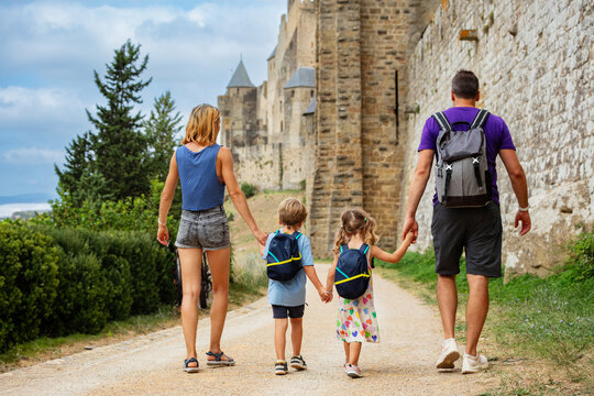 Tourist family with kids enjoy walk along ancient castle walls