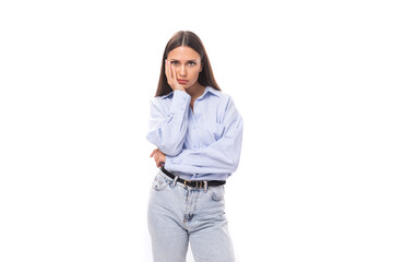 young upset european business lady with long black hair dressed in a blue blouse on a white background with copy space