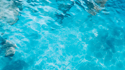 Fototapeta na wymiar Transparent clean blue water, top view. Water with reflections and small ripples on the surface. Texture