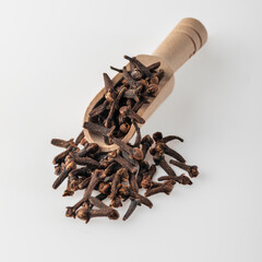 Clove tree buds lie in a wooden scoop..Aromatic cloves used for cooking. Cooking spice.