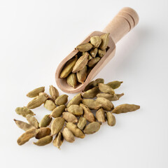 Cardamom seeds lie in a wooden scoop..Cardamom seeds used for making desserts and dishes. Cooking spice.