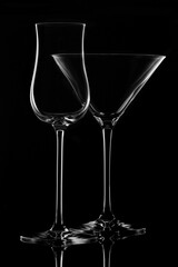 Empty glass wine glass on a black background..Wine glass for a drink on a black background. White silhouette of a glass.