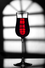 Glass of wine on a black and white background..Glass with a drink on a black and white abstract background.