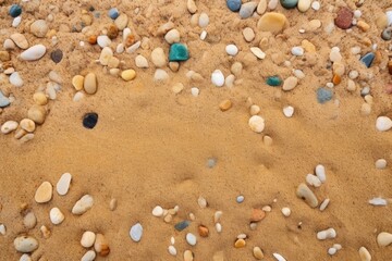 Fototapeta na wymiar a closeup of a sandy beach with small stones