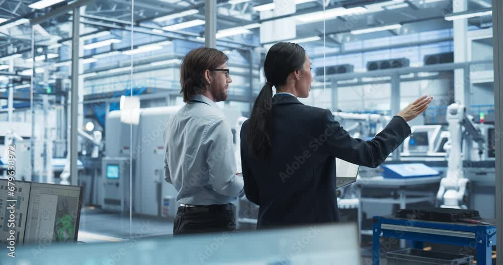 Poster Young Caucasian Engineer and Asian Technician Having a Conversation and Using a Laptop Computer. Specialists Monitoring, Analyzing Conditions at a Modern Electronics Factory with Automated Conveyor