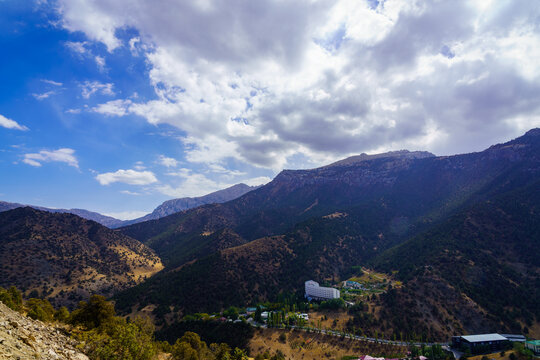 Mountains covered with grass and trees and cloudy dramatic sky on a daytime in Zaamin reserve.