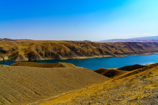 A deserted part of the Zaamin nature reserve in Uzbukistan on a sunny summer day. View of the mountains and reservoir.