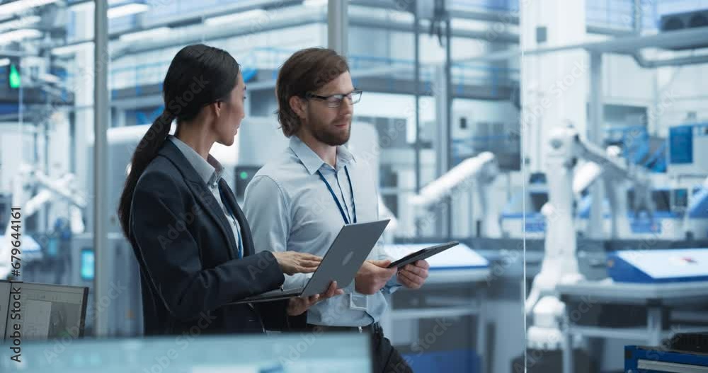 Aufkleber Factory Managers Using Computer Devices at a Modern Manufacture with Autonomous Robot Hands. Female and Male Specialists Monitoring Technical Data, Analyzing Reports and Planning Updates