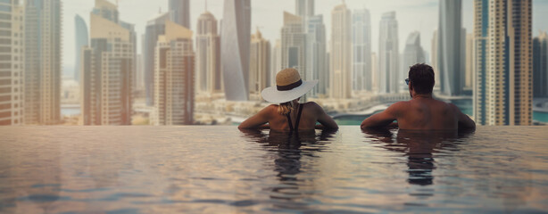 couple enjoying panorama view of Dubai marina from infinity pool. UAE travel. banner copy space