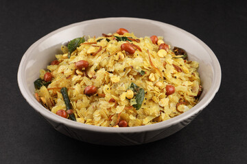 Poha Chivda or Chiwada. Diwali special savory snack, made out of Flattened rice, fried peanuts, curry leaves and some spices. Traditional Indian Diwali Snacks.
